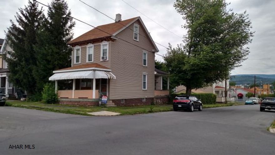 Nice double, corner lot. Features include: vinyl siding, newer windows, 1-car garage, high ceilings, and a walk-up attic. Needs some TLC.