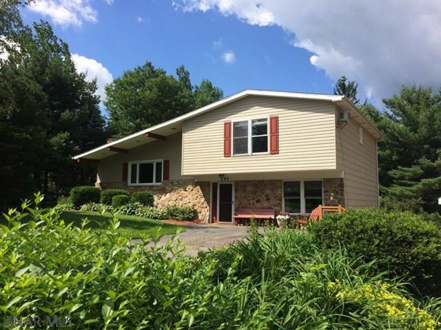 This beautiful home sitting on over an acre is located in a desirable neighborhood. The home has hard wood floors throughout with 3 bedrooms and 2 1/2 updated baths with gorgeous tile work. The large eat in modern kitchen with spacious granite counters will give you lots of area to work, and it is not short on storage either with plenty of cabinets.  Dining area has room to accommodate a large table and has sliding doors to the private deck. The living room features a fireplace, vaulted beamed ceilings with sky lights which make this level airy and bright. The upper level has a built in bookcase with room to sit and read. The master bedroom can easily accommodate a king size bed. The lower level has a spacious family room and office both with cork floors. All major mechanics are newer.