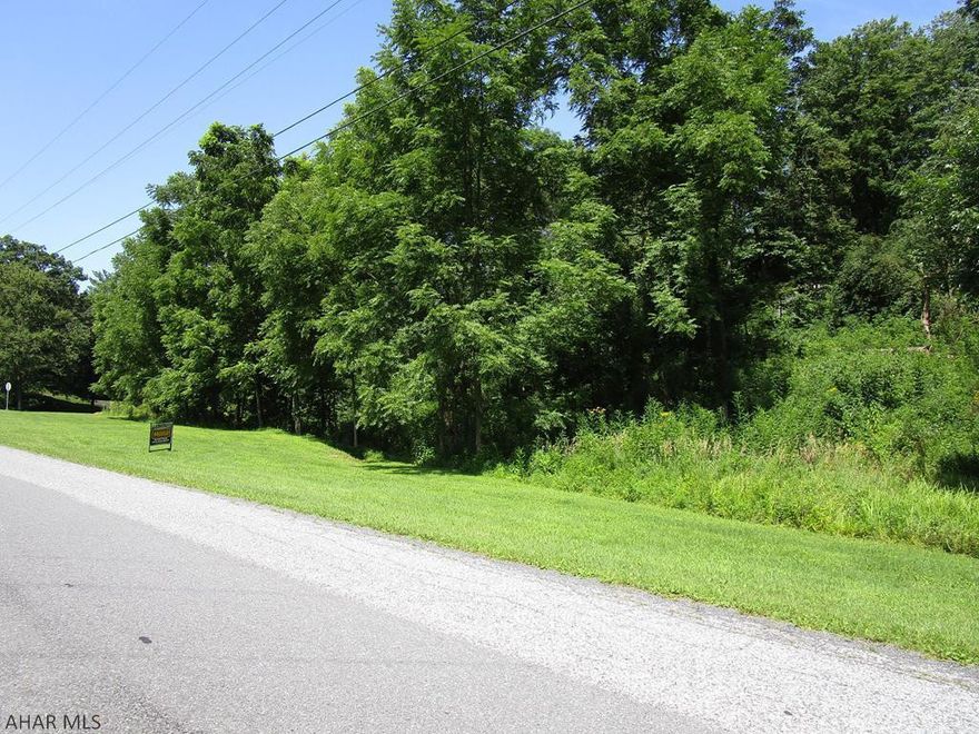 Restrictions apply. Taxes approximate. Water drainage traverses the lot.