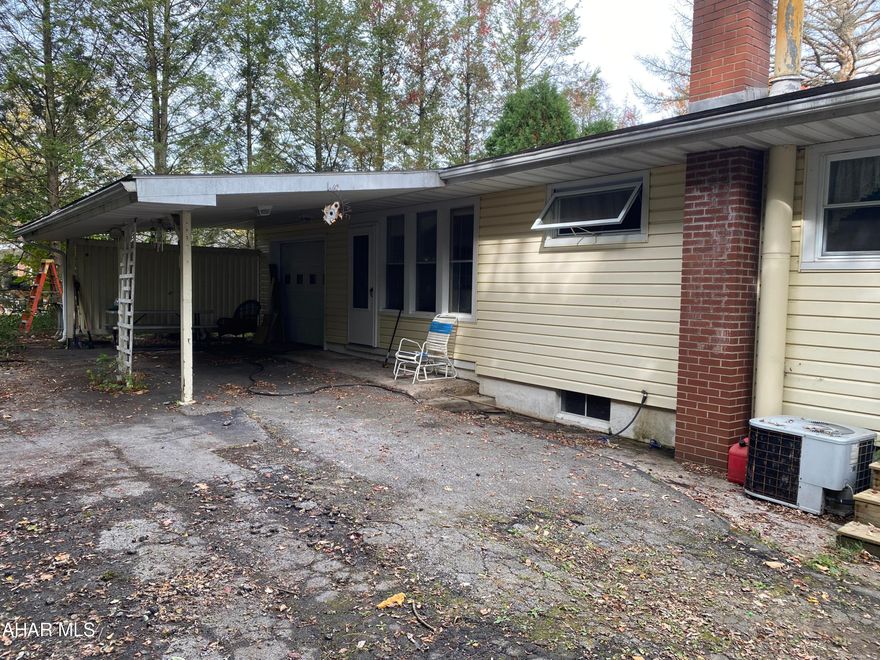 Add your creative flair to this ranch home that sits on a large, private corner lot. It is situated in a nice neighborhood in Logan township. this home features a one car heated garage with a closed in breezeway with entrance to home and entrance to covered patio. The living room has a beautiful view of the mountains along with hardwood floors. Dining room, kitchen, and a large full bath. The 3 bedroom all have spacious closets and hardwood floors. The basement is unfinished but has tall ceilings and wood burning stove and could easily be finished to a large Rec. room with laundry area. There is a great deal of off-street parking. Conveniently located to shopping and restaurants. This home will not last long! Needs TLC.