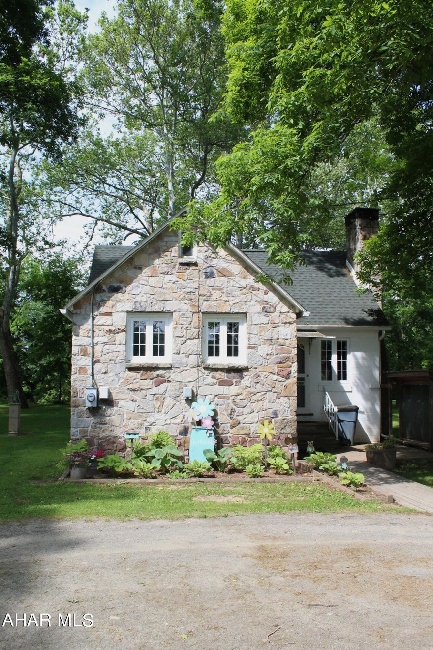 Welcome to your dream retreat! Nestled in the picturesque community of New Paris, PA, this immaculately maintained stone cottage offers the perfect blend of rustic charm and modern convenience. With two cozy bedrooms, one pristine bathroom, and direct access to the serene Dunnings Creek, this fully furnished gem is ideal for a second home, full-time living, or a lucrative rental property.
Step inside and be greeted by a warm, inviting living space that exudes comfort and style. The living room features original hardwood floors, a beautiful stone fireplace, and large windows that flood the room with natural light. The open-concept design seamlessly connects the living area to the dining space and kitchen, making it perfect for entertaining guests or enjoying quiet evenings by the fire. Outside, the property truly shines with its access to Dunnings Creek. Spend your days fishing, kayaking, or simply unwinding by the water's edge. The beautifully landscaped yard offers plenty of space for outdoor activities, gardening, or hosting summer barbecues. A charming screened in porch provides the perfect spot for fresh air dining or enjoying a cup of coffee as the sun rises. 
This charming stone cottage with creek access is a must-see for anyone seeking a unique, serene, and versatile property. Schedule your private showing today and start making memories in this enchanting home!