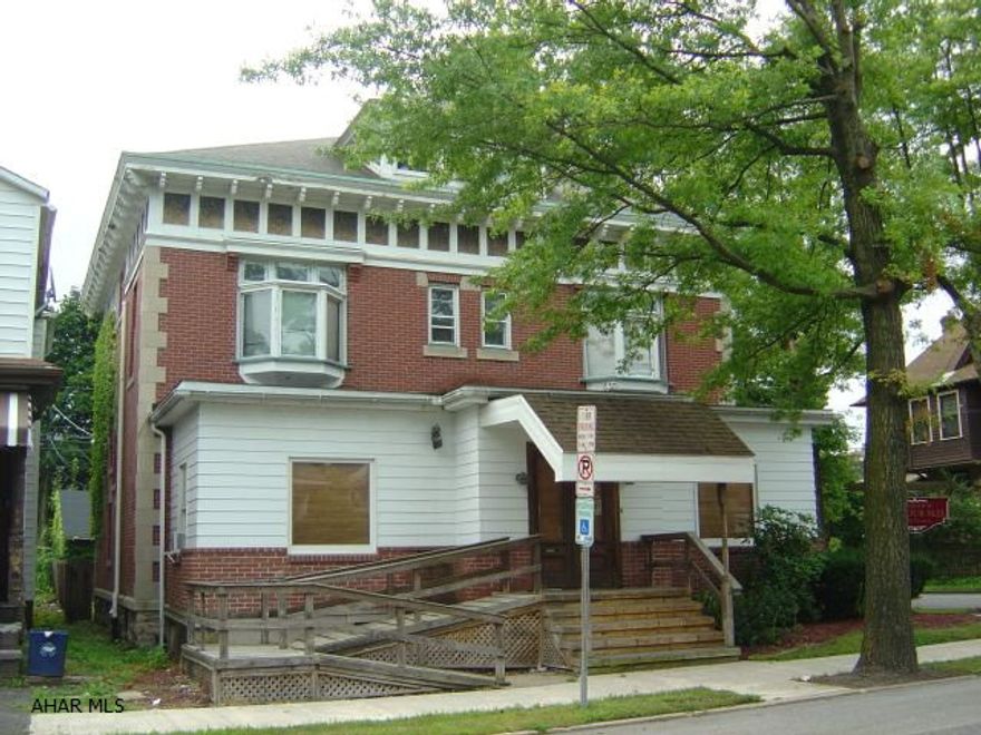 Currently used as a Doctors Office, waiting room, main office, 4 rooms, kitchen, 1 1/2 baths, 2 car garage. 2nd floor , 3 bedroom, 1 1/2 bath, living room, kitchen. Great brick corner property.