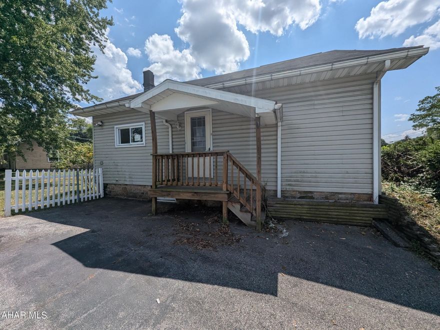 Grazierville/Tyrone area vinyl Cape Cod home with detached workshop/garage and storage building on 0.46 acre lot. Main home features large kitchen with adjoining dining room, formal living room, 1 bedroom, 2 baths and den all on the first floor. Second floor is 2 bedrooms. Needs some TLC, but lots of potential for investors or handy persons. AS-IS sale,, seller will make no repairs.