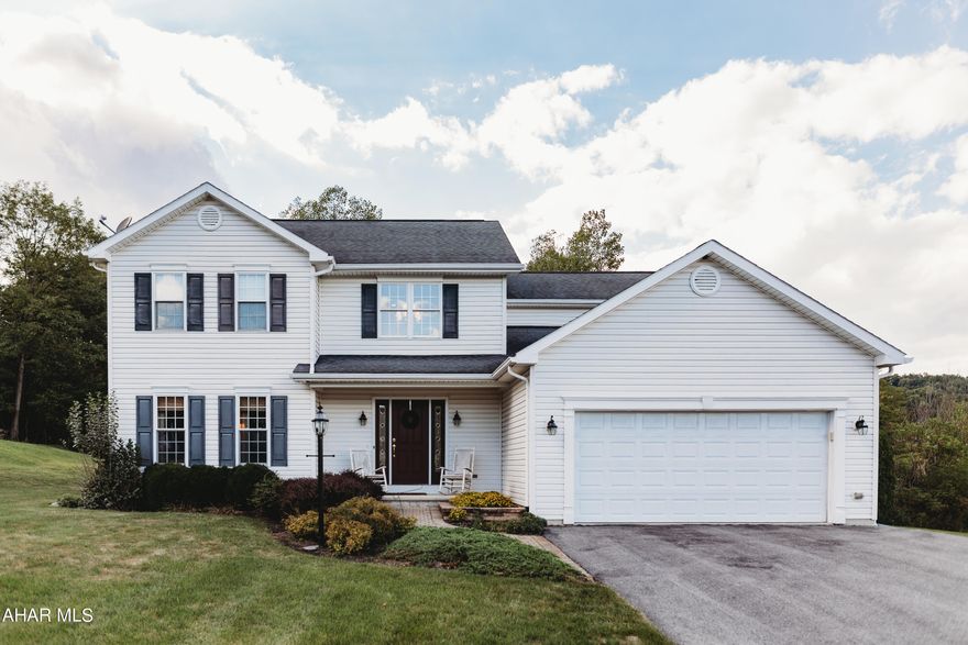 Lovely two story home on .23 acres! Features 3 bedrooms and 2 1/2 baths. Formal dining room.  2 car garage with storage. Hardwood flooring throughout. Deck with electric canvas awning out back for entertaining your guests. This home is a must see!