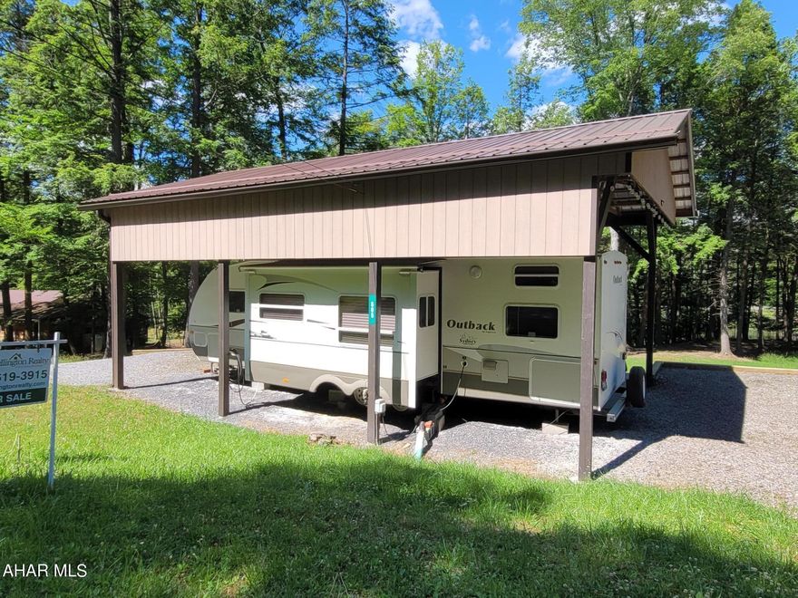 This one of a kind property has plenty of space both inside and out.  The two bedrooms in this attractive camper sleep six in beds and two to three more with the sleeper sofa and table bed.  Outside, the camper is placed in the middle of two lots facing the catch and release pond.  A pavilion covers both the camper and an outside area so you can be outdoors in most weather.  There is an additional electric and sewer hook up for occasional visitors.  The seller is leaving some dishes / pans, bedding, grill and outside furniture.  
This campsite is located in Glendale Yearound, a gated community with a community pool, tennis/basketball/volleyball courts, dog park, playgrounds and pavilions.  The development is adjacent to Prince Gallitzin State Park / Glendale Lake.