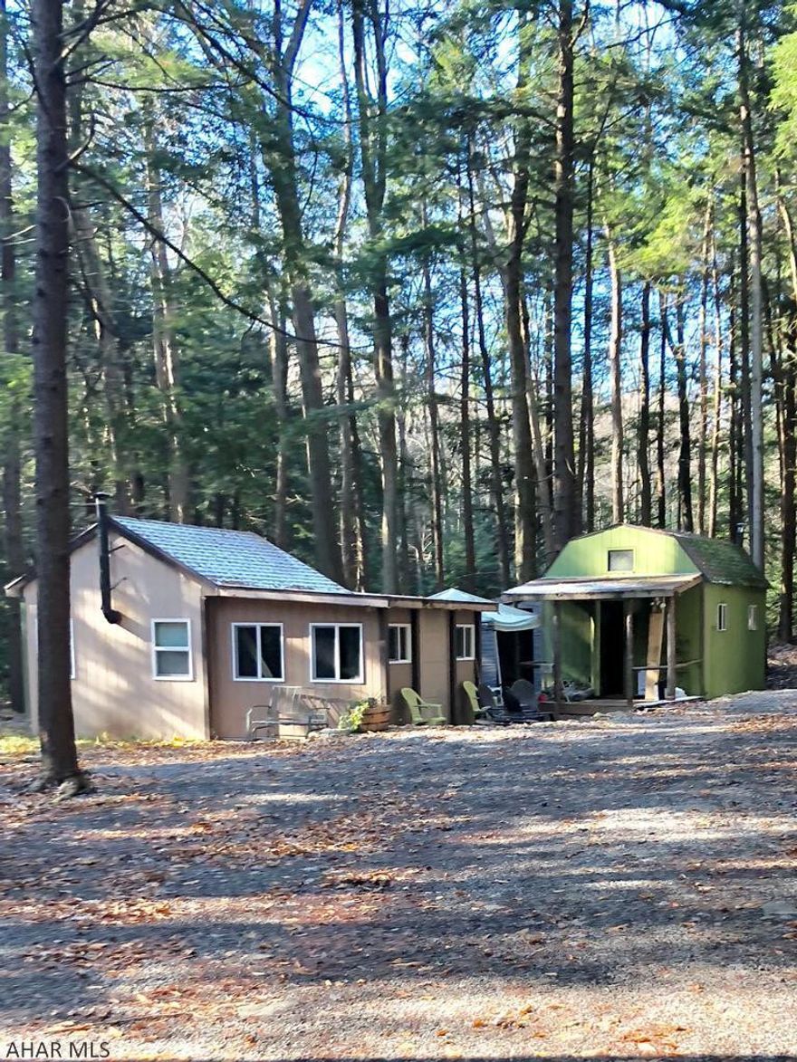 Private, level Hunting camp on 3 acres with lovely creek and spring water creek. Camp includes 3 Buildings:  Newer constructed House or 3 room building (no electricity, or running water). Uses a wood burner stove for heat and generator for lights.   2nd building is shed with a loft.    3rd building is an outhouse on buried cement septic tank.   Call Listing agent for hunting info. There is electric at the road not to camp..