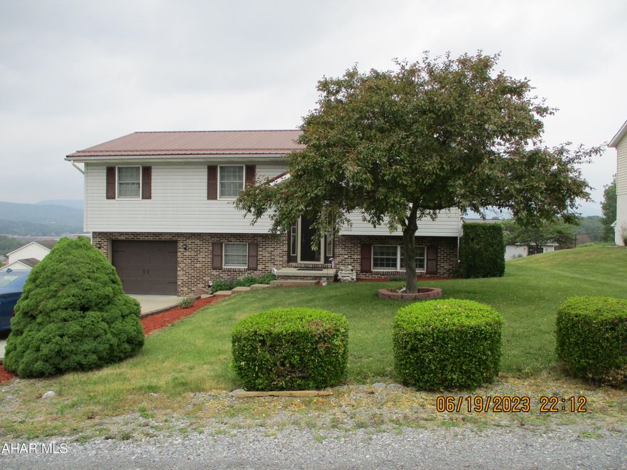 Super location with panoramic mountain views.  This bi-level is ready to be your new home.  On a corner lot in Logan Township, it features three bedrooms, 2 1/2 baths, eat in kitchen, and formal dining room.  Covered porch for warm summer evenings.  Family room in lower level.  Great storage space.  New steel roof in 2022, new furnace and A/C in 2018, well tank and pump new in 2021.  Softener is owned.  New front door. Range new in 2017.  Additional gas heater in lower level family room.  SELLER OFFERS $10000 IN CLOSING COST OR UPGRADE ASSISTANCE AT SETTLEMENT.