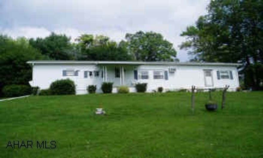 Well kept and updated mobile home with shaded screened porch, 2-car garage, large storage building on beautiful lot with great view. Newer pitched roof, tilt in windows, flooring, front stoop and redecorated kitchen. Kitchen appliances available.