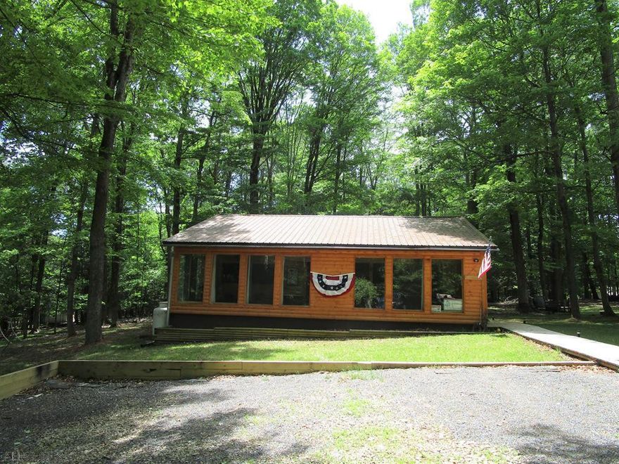 Come take a look at this log home situated on a partially wooded lot in the desirable Glendale Yearound.The 3 BR, 2 bath log home is situated on a 0.38 (45x180) acre parcel & also includes the adjacent parcel that is 1.23 acres & deeded separately. There is nothing left to do on this property except to move in! New kit. w/stainless steel appliances. FR has 8 floor to ceiling windows. First floor laundry with stackable washer/dryer included. New metal roof. GFA furnace w/heat pump & central air. 36x12 deck in back to sit & watch the wildlife. Shed for storage. Basement area offers a BR & full bath. Assoc. dues include security, trash, road maintenance & maintenance of recreational facilities such as the club house, swimming pool, dog park, playground, tennis/basketball/volleyball courts.