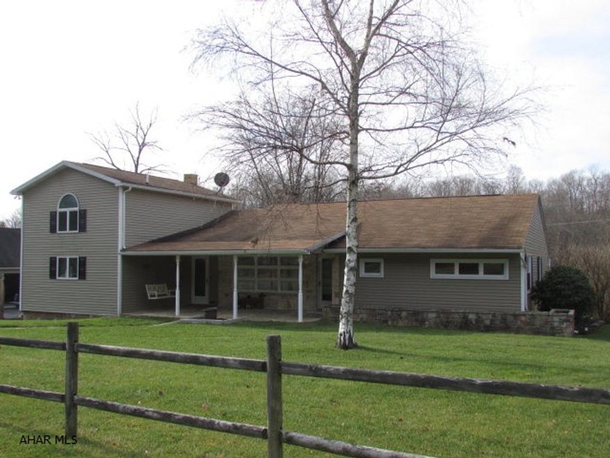 Spacious home with creek near State Game Lands. 20 minutes to I-76 Fort Louden. 45 minutes to Lake Raystown. Has 1.33 acres with a nice creek for fishing and beyond the creek is hunting land. Large 3-car garage with overhead storage plus 1-car garage w/workshop at back. Large back deck partially covered w/hot tub. Cozy front porch of stone. Large LR & DR. Nice kitchen w/lots of cabinets/pantries. Three bedrooms with hardwood floors and big closets plus large closets in hallway.  3/4 bath on main floor. Upstairs has bedroom with built-in bookcases, window seat, half bath. Driveway is paved. Oil hot water heat with two wood inserts and one wood stove. Partially finished family room in basement. New siding plus some new windows. Well maintained property and surrounding properties.