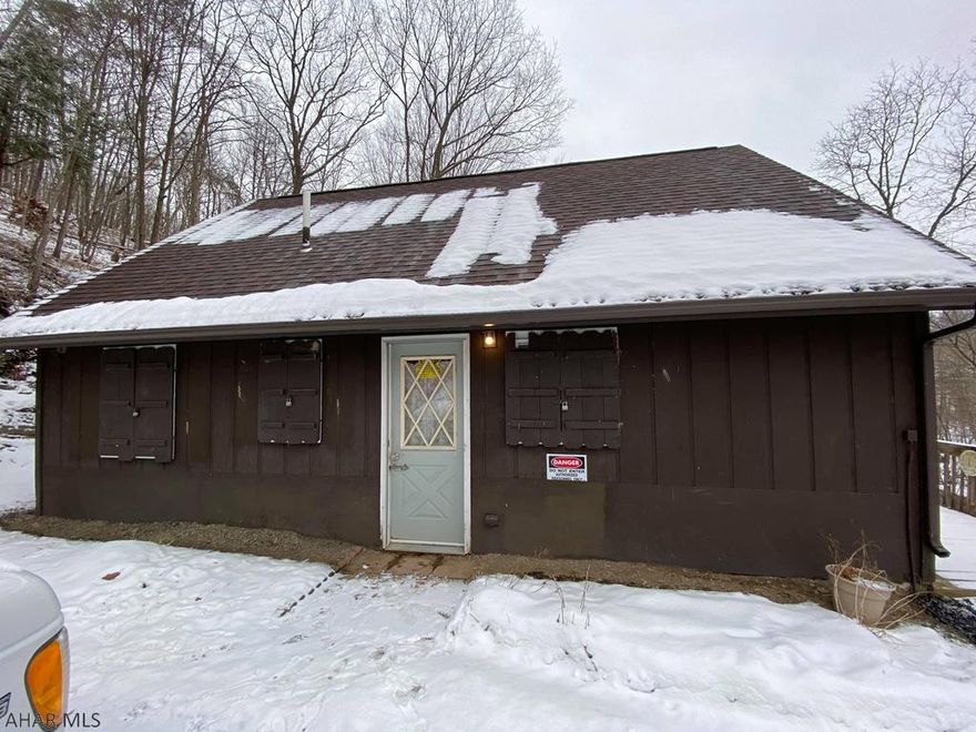 Cozy cottage on wooded hillside overlooking Dunnings Creek.  Very open floor plan that includes one bedroom and one full bath,  kitchen, big living room with dinning area and loft for second bedroom or more living space. Relax on the deck above the river watching fish jumping, Eagles, Deer and Turkeys. Private and secluded but easy access on a very well maintained township road. Property includes 1.96 wooded acres with frontage on both sides of Dunnings Creek. Telephone, Electric, Septic system and well.  The cottage s not in the floodplain, but a portion of the property is.