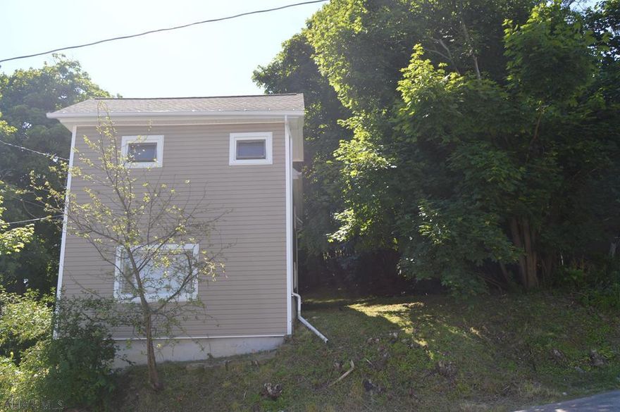 Move-in ready home! Completely renovated in 2012 with all new plumbing, wiring, hot water tank, kitchen and bathroom sinks, freshly painted walls, carpet, and laminate wood flooring. New roof and siding in 2014. Beautiful kitchen with built-in pantry and counter seating. Modern bathroom with built-in storage shelves. Convenient 1st floor laundry with finished mud/coat room. Off-street, private driveway and spacious wooded yard along with a deck and porch located on the side of the house.