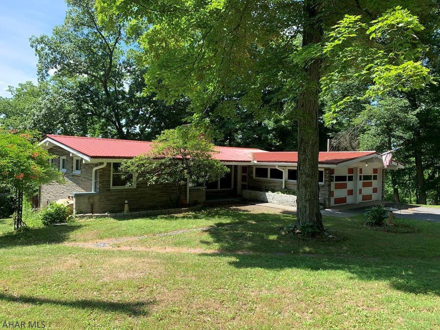 Awesome property close to Downtown Bedford, secluded w/ views of mountains! Tons of light via many windows, Hardwood floors upstairs and laminate floor downstairs, stone fireplaces on both floors, custom kitchen cabinets, 3 Season Room off the dining room with gorgeous views, 2 of 3 bedrooms have outside access to deck and patio, 2 garages: 1 two-car integral garage and one pole building garage built in 2005, all on 2.84 acres with underground electric. Custom plant arbor, metal roof installed 2009, sun-room added 2007, well house with Martin conditioner, 80 gallon water heater installed 2017, newer bedroom and kitchen windows, new wood-burner fan. Gem of a property with so many possibilities including multi-family living with full kitchen, bath, living rooms and bedrooms on both floors!