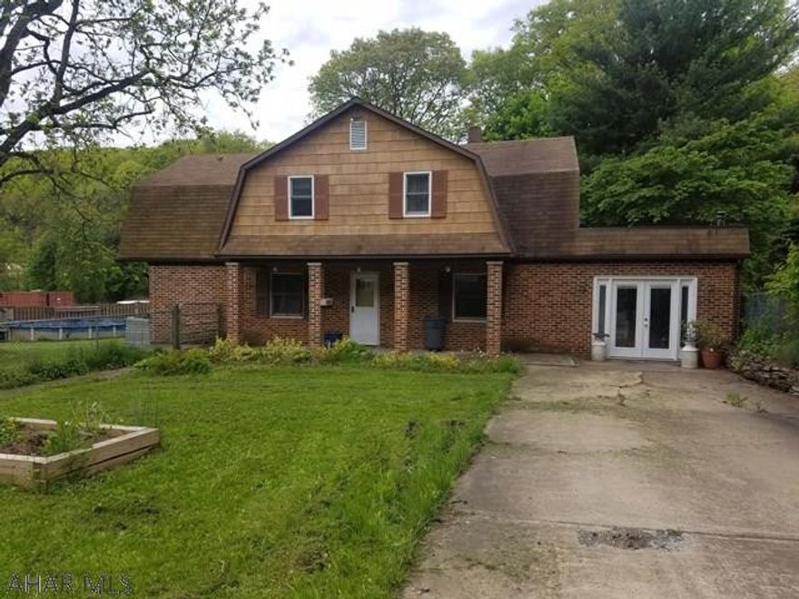 This spacious home is truly one of a kind!  3 bedrooms, 2 huge bathrooms, cozy addition family room with stone fireplace, hardwood floors throughout, a kitchen bar and that's just the inside!  Outside boasts a pool and lots of off street parking.  At this price, it won't last long.  Call today!!