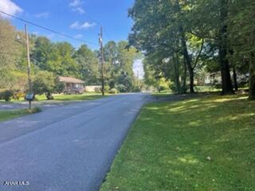 This structure has the appearance of a residential ranch home. It had been used as a n office building. There are 4 rooms and a 1/2 bathroom. Full unfinished basement. There is a large, blacktop parking area in the rear. This building could be a daycare possibility.