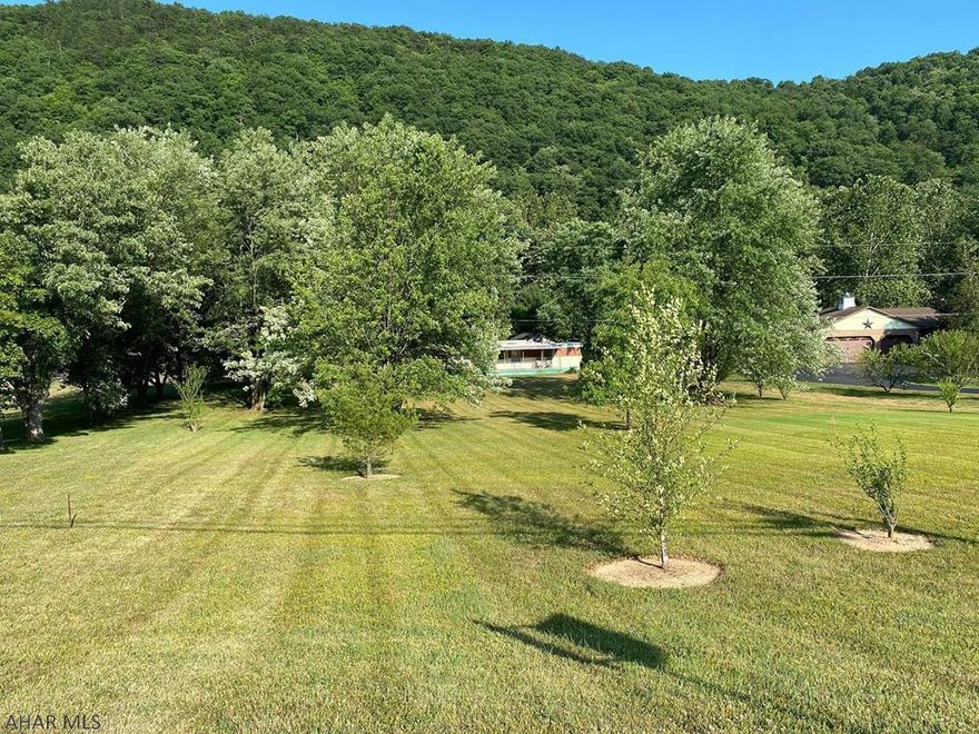 Great recreational home!  This 3 bedroom 1 bath single wide home sits on 2 acres.  Back yard gives private access to the Raystown Branch of the Juniata River. Great Fishing.   Beautiful view from the front and back porch. 2 car garage with attached area for extra storage.  Close to Lake Raystown, Historical Bedford and Blue Knob Resort