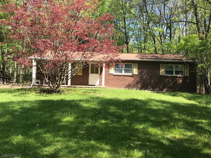Nice gem in the woods lovely setting on the hill away from the road. 3 bedroom bath and a half. basement could be finished into a nice are some work started has a wood burner in  place