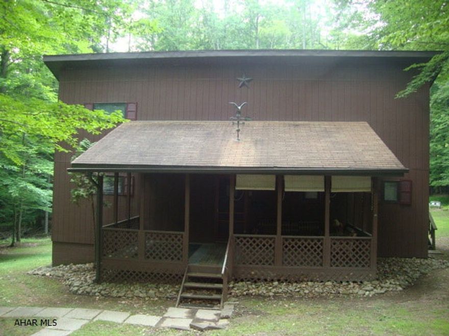 Here's a charming 3 bedroom Cape Cod style home on a very private 1/2 acre lot.  Enjoy all the amenities of Glendale Yearound.  Association fee is only $451 a year.  You can move right in. All appliances are included.  Living room has a wood burner for those chilly nights and frosty mornings.  Home has wall-to-wall carpeting and a full unfinished but finishable basement.  Plenty of space to watch the wildlife from the roomy front porch and large rear deck.  Enjoy all of the wildlife.  Home is within walking distance of pools, tennis courts and playground.  Great vacation getaway or permanent year round home in a gated community.