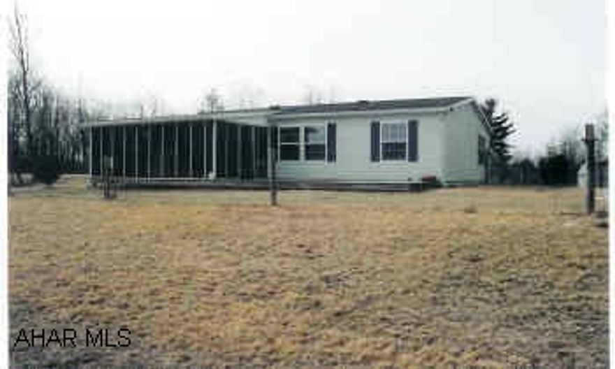 Newer Doublewide home located on wooded 3+ acre site with mountain views. Vinyl sided home with little used carpet & linoleum flooring. Home has nice master bedroom/master bath w/garden tub. Carport and shed being sold with the property. Catherdral ceiling throughout the home.