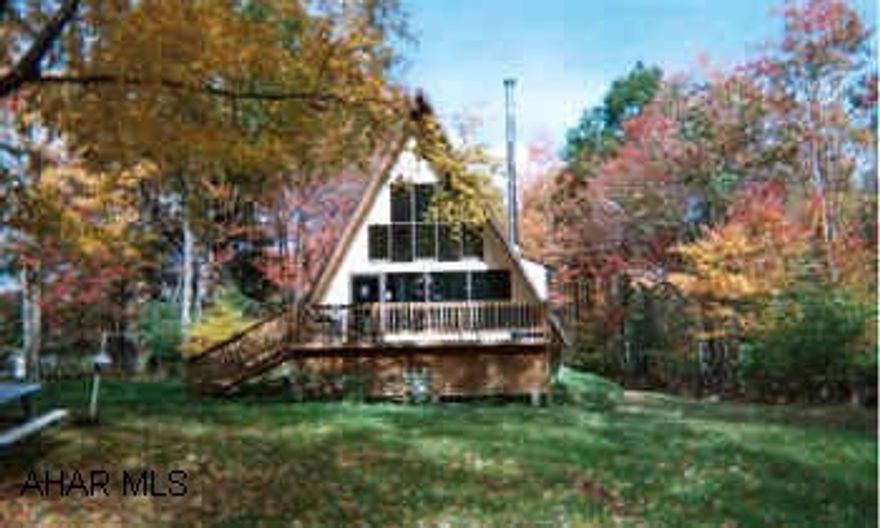 A-frame on 2.5 acre lot. Woodburner. Deck. Shed. 2 car det garage. Call for more info.