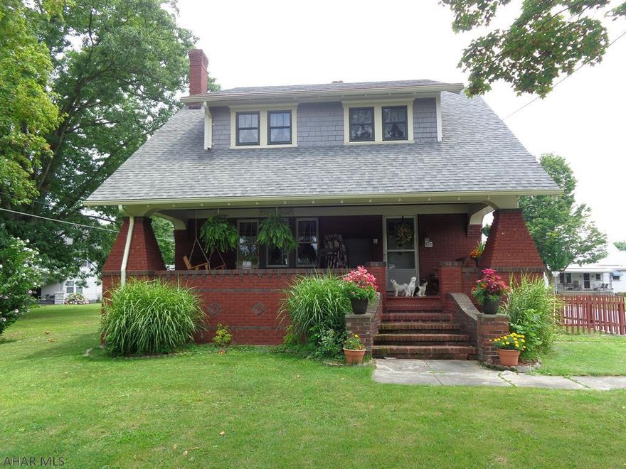 This home has so much to offer with its age old elegance.  Original hardwood floors & woodwork, laundry chute.  All 3 bedrooms have 2 closets.  Newer kitchen cabinets, countertop & roof.  2 car detached brick garage with new metal roof.  Spacious walk up attic is great for storage. Fenced in side yard.