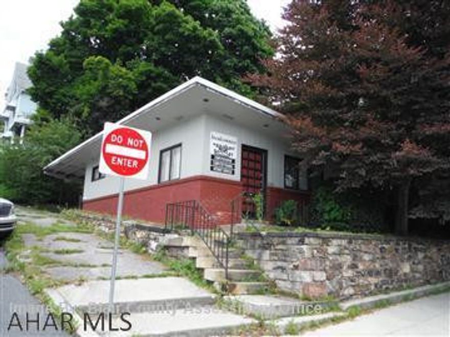 1 Story brick commercial building on corner lot. Needs completely gutted. Off street parking.
