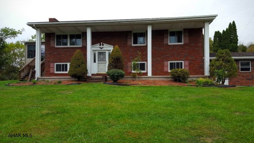 This large 3 or 4 BR, 2 BA bi-level, brick home is located in a secluded area near Bellwood. A beautiful sunroom, screened in porch, large family room with a fireplace, two bonus rooms in the lower level and an oversized garage are just some of the features of this one of a kind home. The large, above ground pool has a deck that can be ready for your family this summer.. The sunroom has floor to ceiling glass with beautiful, private views and is heated and air conditioned for year round use.   The garage is oversized to allow for lots of storage.  The dining room is open to the kitchen which is big enough for an eating area.  There are tons of cabinets and the kitchen looks out to the pool and back yard.  The extra space in this home is just what you've been waiting for!