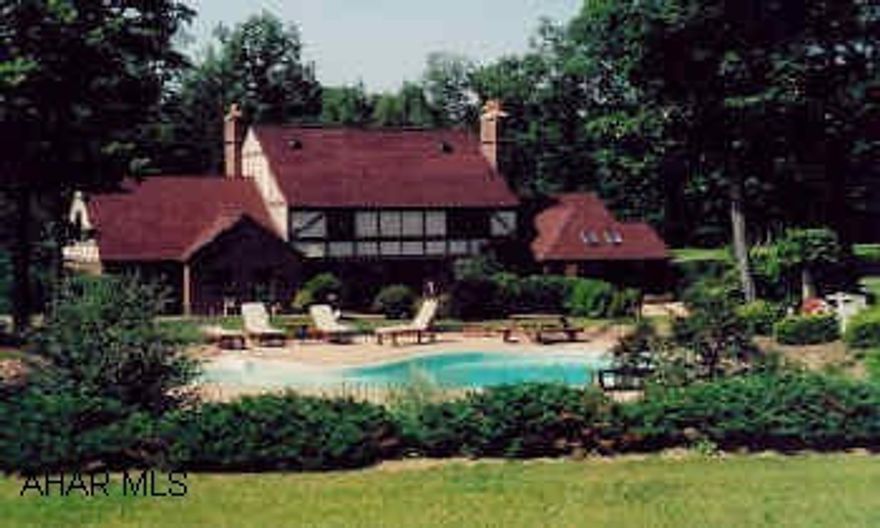 Expansive two story English Tudor on 10 private acres. Inground pool, patio, greatroom with fireplace and wet bar.