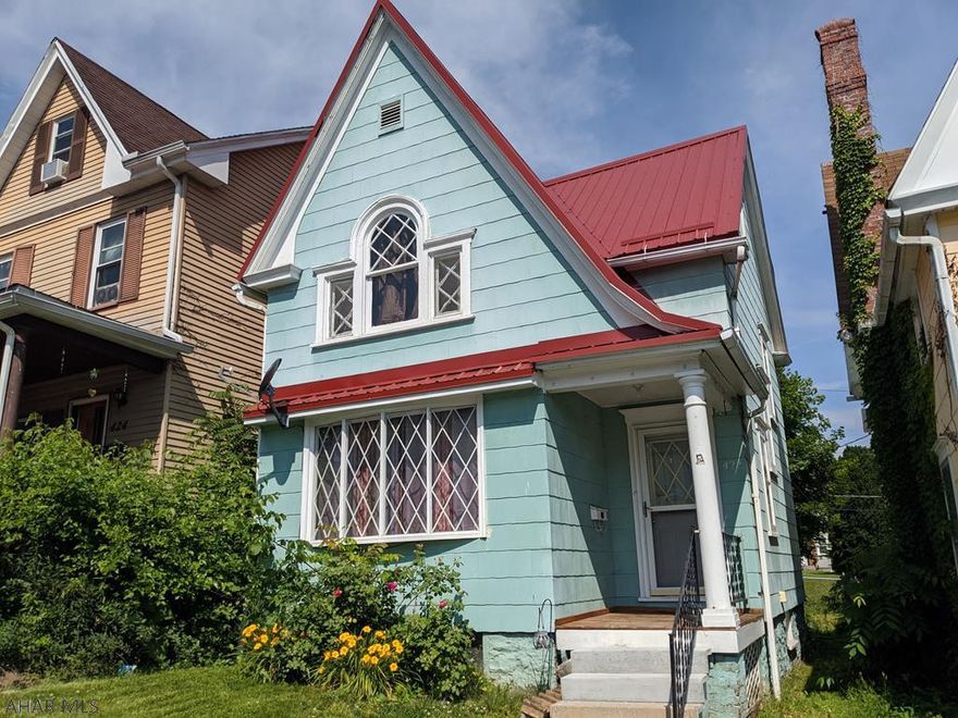 Three bedroom Fairview home with newer metal roof, furnace, hot water heater, laminate hardwood floors - ready for you to move in. Includes appliances! Enclosed back porch and off street parking behind the house. Fenced in yard.