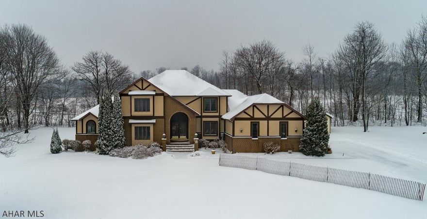 Stately Tudor home sits atop a 1 ac. setting graced by mature trees.  Beyond the beautiful curved entrance and solid oak doors introduces you to open Foyer with ceramic floors, oak Staircase, sunken Formal living room and tray ceiling dining room with inlaid hardwood floors.  Fabulous open concept for family rm. eating area and kitchen boasting tasteful woodwork, cherry cabinets, Corian counters, large breakfast area, provides plenty of room for entertaining.  1st floor Master bedroom has split shared wall fireplace with family room and tray ceilings.  1st flr. Master bath layout has vanity with his/her sink tub area and shared area for shower & commode.  2nd floor has 4 spacious bedrooms, 2 Jack/Jill bathrooms with his/her sinks.  Attached heated 3 car garage, Agent related to Seller.