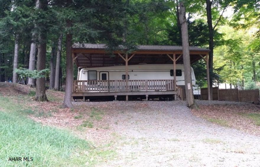 1997 34' Carriage 5th wheel camper with a deck and pavilion on a campsite in Glendale Yearound. Enjoy the outdoors with your own campsite and camper at Glendale Yearound near Glendale Lake. Your camper is protected by a pavilion which means you can enjoy being outside in any weather. Enjoy the community pool, playgrounds, basketball, volleyball and tennis courts in this gated community. Everything in camper works and has been well maintained.