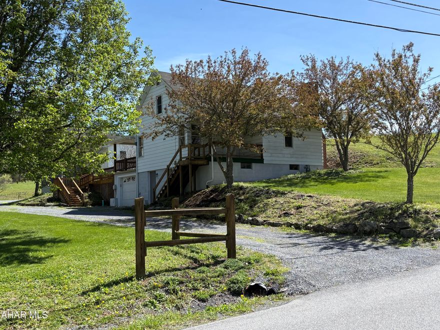 Tucked into the peaceful countryside just minutes from one of Bedford County's most iconic destinations, this charming property offers space, versatility, and opportunity on 2.8 scenic acres. Located only 3 miles from the historic Omni Bedford Springs Resort, you'll enjoy the perfect blend of rural living with close proximity to golf, dining, spa, and recreation.

The main home features 3 comfortable bedrooms and 1 full bath, highlighted by a spacious country kitchen that serves as the heart of the home -- ideal for gatherings, everyday living, and creating lasting memories. Step outside onto the oversized deck, large enough to host a full gathering, where you can take in the quiet surroundings and open skies of Sweet Root Road. The home is ready for a new owner's personal touch, offering the opportunity to make it truly your own while enjoying its solid foundation and peaceful setting.

This property truly shines with its additional living and functional spaces. A two-car detached garage includes a fully equipped 2-bedroom, 1-bath apartment, perfect for rental income, guest quarters, or multigenerational living. Nearby, the large barn with attached lean-to offers solid structure and excellent potential for hobby farming or small livestock such as chickens, making this an ideal setup for those seeking a farmette lifestyle.

Whether you're looking for a primary residence, weekend retreat, income-producing opportunity, or a blend of all three, 496 Sweet Root Rd delivers flexibility, charm, and country character in a highly desirable Bedford location.