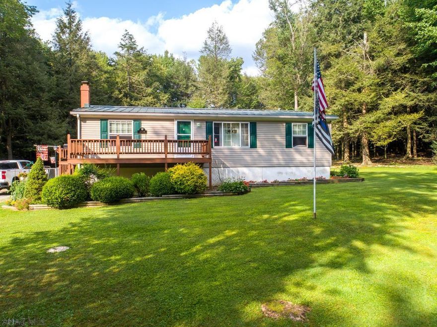 If you are looking for a more private setting, this meticulously maintained property that sits back off of the road on approximately seven beautiful acres is the one for you. House is perfect for entertaining family and friends, the kitchen is open to the dining and living rooms, and the basement has a bar area with half bath that is sure to please the guests. The fire pit in the back yard is the perfect center to make mountain pies while enjoying all the wildlife. Fenced area for pets, detached garage to store toys. Many newer updates to this property, new roof in 2015, remodeled kitchen and bath, new hot water heater 2016, new laminate wood flooring throughout upstairs. Seller is subdividing land. House/garage will be on approx 7 acres. Seller would consider selling additional acres.