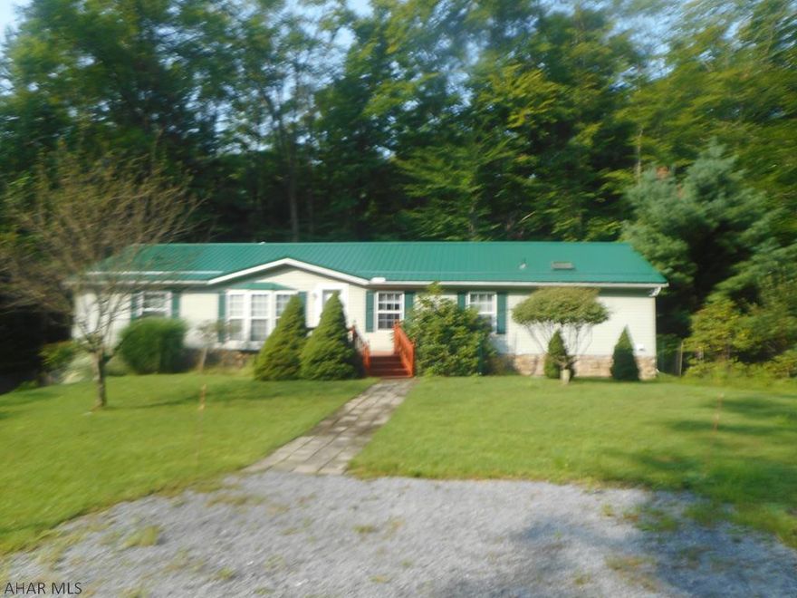 Beautiful well maintained doublewide on a full foundation. Large equipped kitchen with center island, large living room with vaulted ceiling and fireplace, two full baths with the master bath having a separate shower and garden tub, full basement with two car integral garage. Rear shed and fruit trees. Great home value here. Gated community with many amenities.