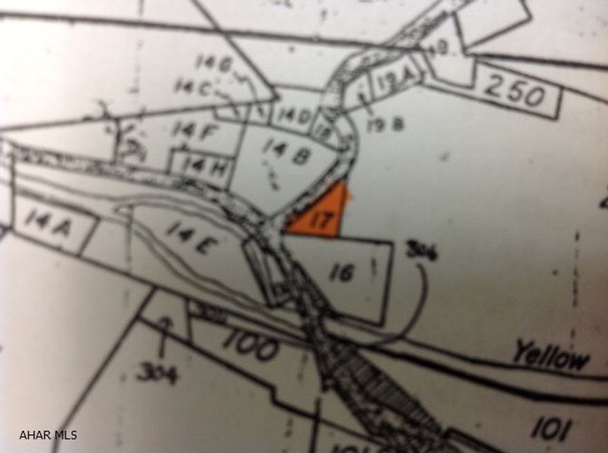 Wooded flat 1.1 acre with a holding tank and electric. There use to be a camper trailer on the property.  This property is commercial zoned and with permits you could have some type of business like a ice cream stand or a barbecue pit.  Corner of property is in a Flood Plain.
