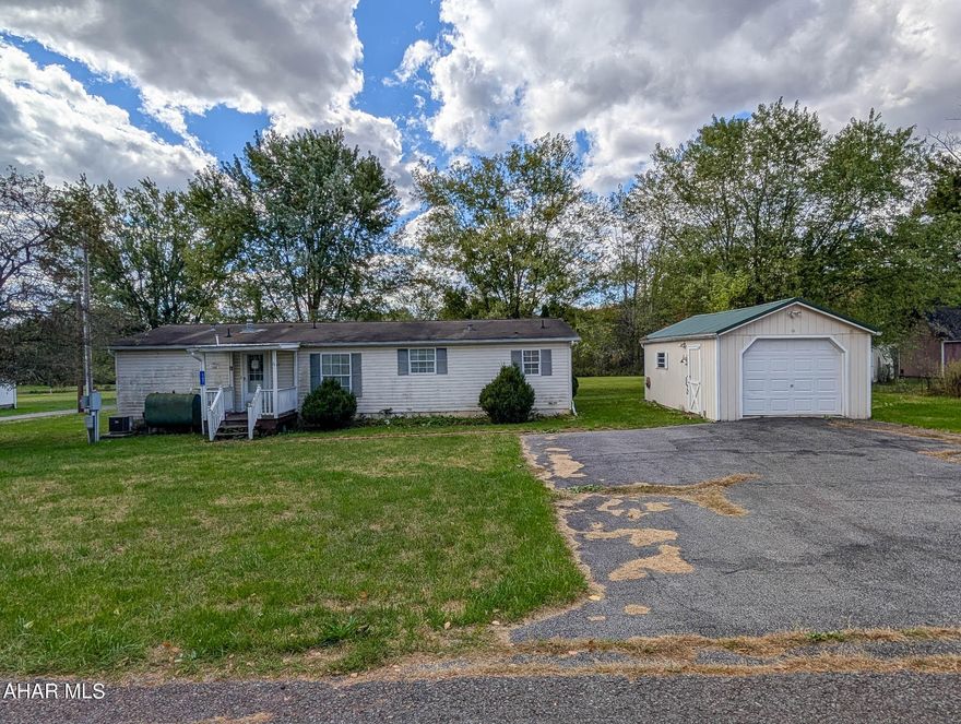 A beautiful lot on a quiet side street setting with over a half acre of property! There is a one car detached garage and garden shed on the property, and it includes a blacktop driveway and parking area. The double-wide home is situated on a concrete slab foundation.   AS IS WHERE IS.