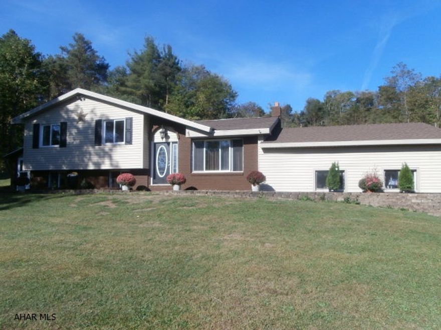 This home is in great condition and is move in ready! Hickory kitchen with appliances and new hardwood flooring, Knotty pine basement finish in the family room and office, propane free standing fireplace, new carpet throughout, attached two car garage. Nice level parking area, new roof - too much to list! Great location 15 minutes from the city.