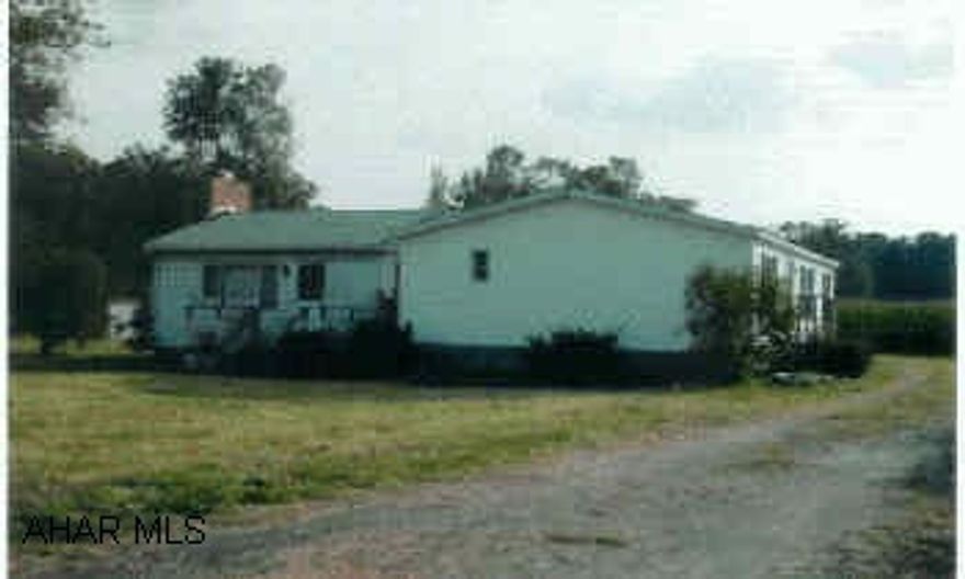 1995 Doublewide with new addition, family room with slate fireplace and covered rear porch. 3BR/2BA