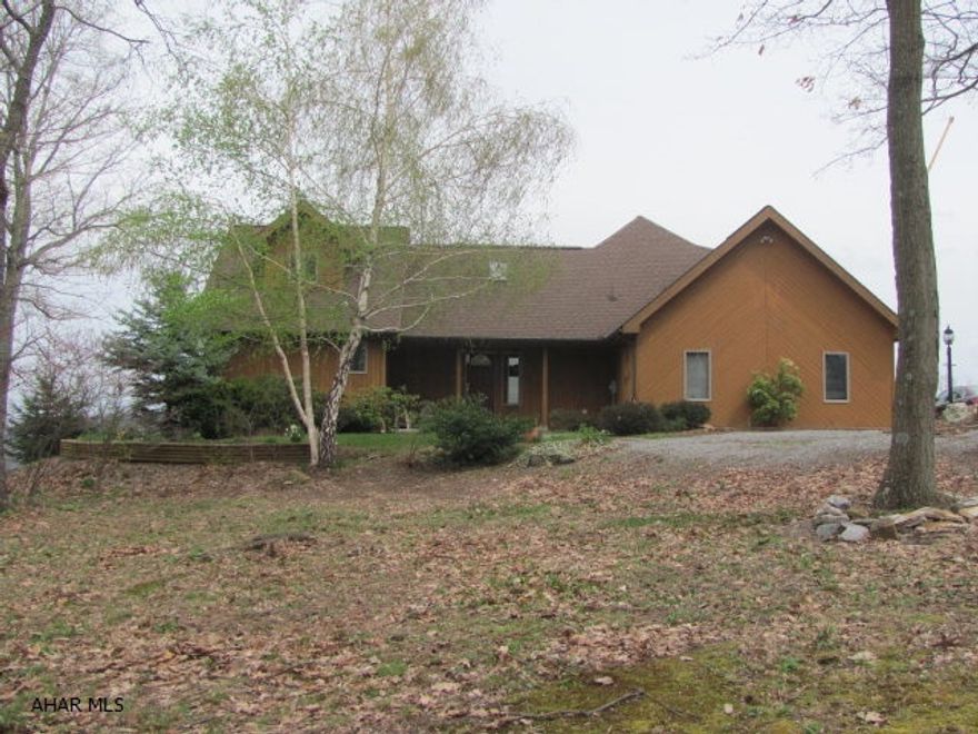 Magnificent views of Lake Raystown and the Marina. Custom designed cedar home on 1+ acre. Located minutes from Lake Raystown and the Marina. Floor plan has been carefully thought out.  Wide open design affords great space. Bedrooms located to allow you to retreat to your own private retreat. Custom floor to ceiling stone fireplace in LR. Open custom kitchen. Vaulted ceilings. Floor to ceiling windows with incredible views. Boarders Army Corp of Engineers property and Bald Eagle habitat. Custom railing leads to upper level. This 4 bedroom, 3.5 bath custom home is a must see.