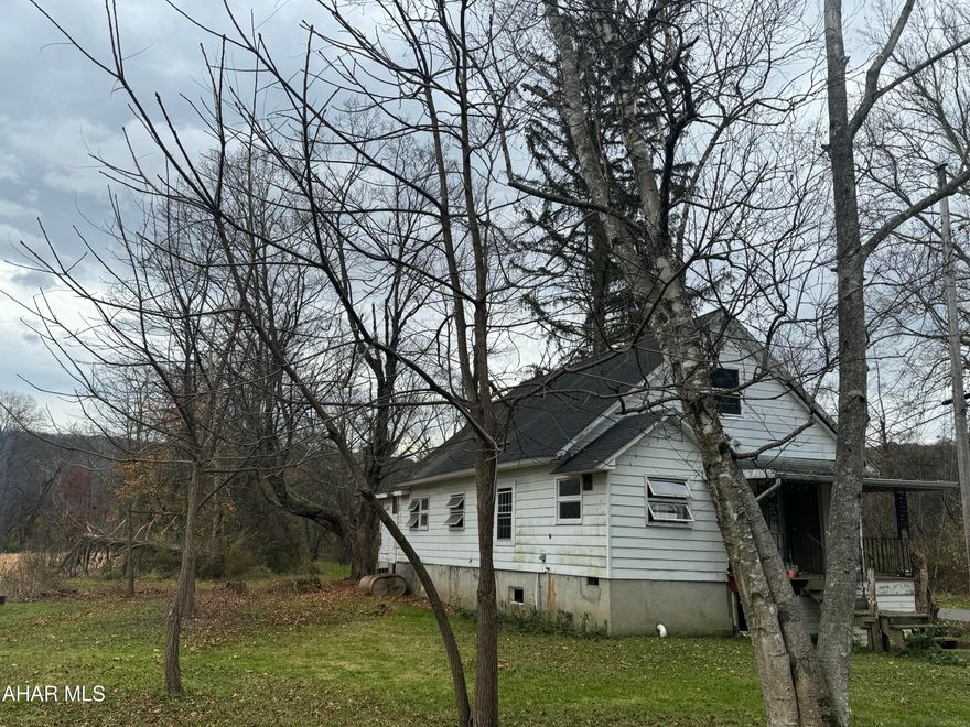 This property has 4 lots and has a 2 story garage that has a newer metal roof.  The house will need fully renovated.  This is located in close proximity to Canoe Creek State Park.  This property would make a great vacation home or AirBNB   Huge yard would be great to park your camper on and fish the Juniata River.  Property has a well and septic system on site.  
This property is being sold 'as is'