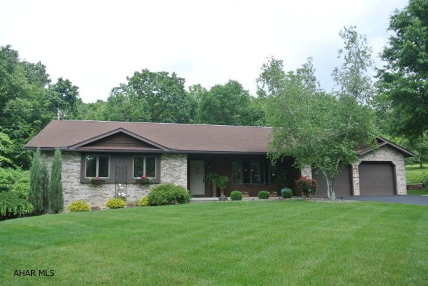 So many amenities...HW floors, new master bath w/tile & glass shower, heated tile floor for chilly mornings. Kitchen features center island, Corian countertops,new SS stove & built-in MW. Main bath has been updated. 1st floor laundry is unbelievable, tons of storage & countertops. Lower level has been totally updated as well. There's a wet bar, gas FP and an office with built-ins. Outside you have the option of deck seating or enjoy the screened porch with cable tv access. Plenty of Perennials, raised beds and flowering trees. There is also a well for watering lawns & washing cars. 2 driveways, each with a 2 car garage.