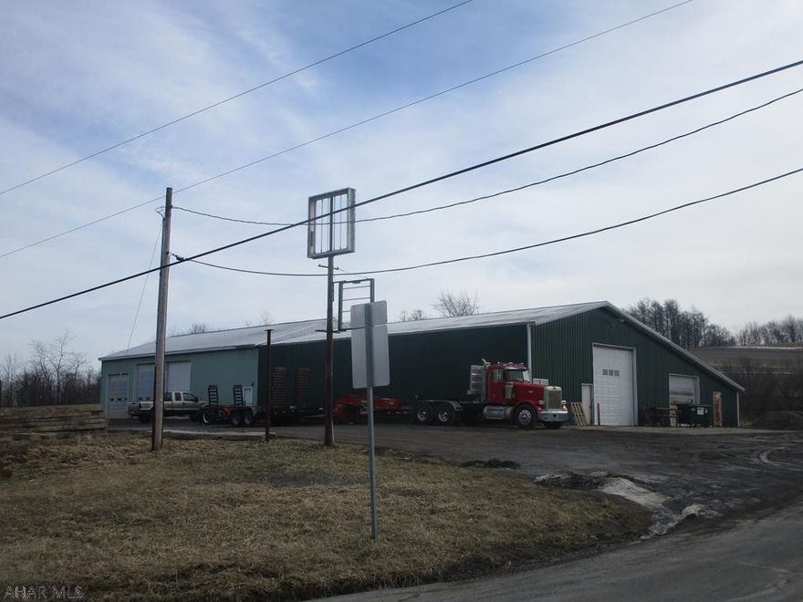 Large garage currently used for excavating/trucking business. 3 -14 ft overhead doors and 1-12 overhead door and a 8' overhead door. 16 ft  interior ceiling height. Concrete floors and 1/2 bath. Coal heat (approx $900 yr to heat). 2 room office and an overhead parts room.  Great garage in a country location.