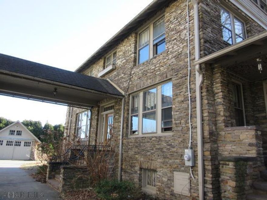 Beautiful stone house with quality throughout- hardwood floors and original woodwork, spacious 3 bedrooms, 2.5 baths, enclosed porch areas, built-ins