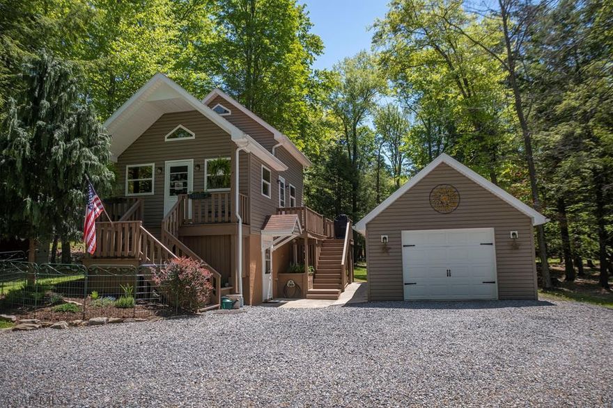 Whether you are looking for a cozy nest for two or a getaway for family this well cared for cabin could fill the bill.  Three levels of living space afford room for all to enjoy separate activities.  Lower level is currently a media room but could be redesigned as a bedroom.  The loft bedroom offers views of the living room as well as the view.  Wrap around deck off of the kitchen allows you to eat inside or out.  Lovely landscaping.  With two garages and a large shed you will have plenty of room for your vehicles, tools and toys.  Enjoy the community swimming pool, club house, tennis courts and playgrounds.  There is a place for Fido at the dog park as well.  Adjacent to Prince Gallitzin State Park / Glendale Lake, State Game Lands and six miles from Rock Run ATV Park.  Don't wait!