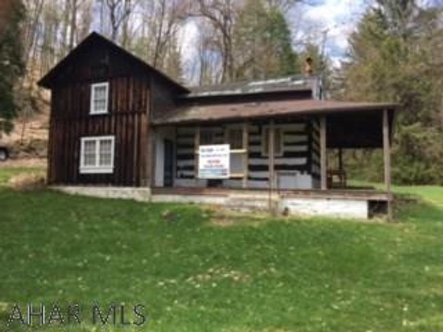 300 +/- Acres in Sinking Valley all wooded except 3 acres where the log cabin sets.Cabin is indeed of a roof and 2nd floor repairs due to leaking for years. Please use caution if you enter cabin, 2nd floor is not safe to be on. Great hunting and would make a fantastic home build site.