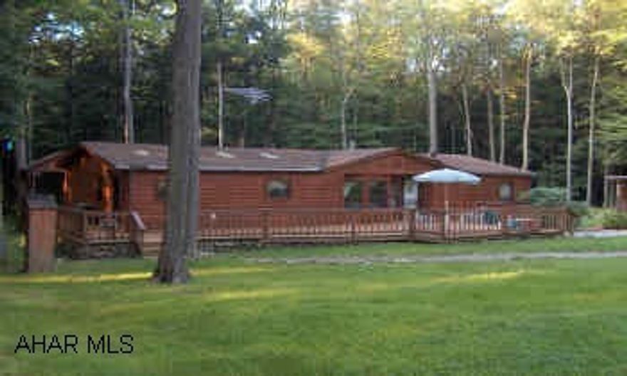 Log sided doublewide on two wooded lots in Glendale Yearound. Fireplace, valuted ceiling, quiet location.