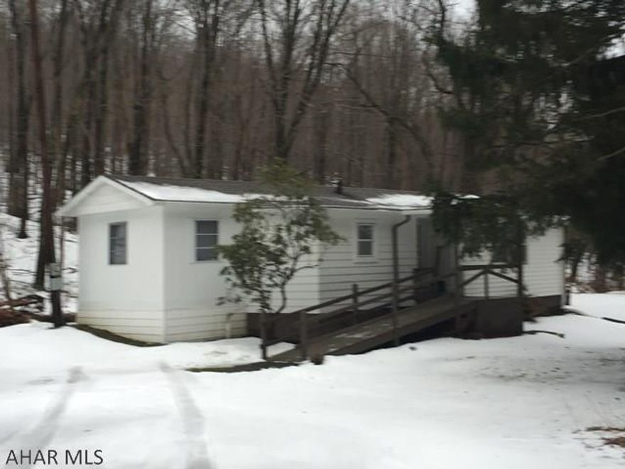 Great country setting with stream and woods. Nicely remodeled older mobile home.  Property also includes a large detached 2 car+ garage. Wheelchair ramp included. Must see interior.