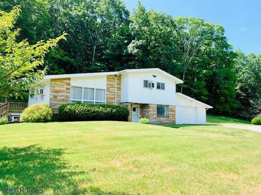 Very well maintained custom contemporary home on 1.4 acres. Beautiful hardwood floors throughout!  Entering through the spacious foyer leads you up the spacious living room with a cathedral ceiling and wood beam accent , kitchen and dining area. The kitchen features the newer microwave, stove,dishwasher and side by side refrigerator with white cabinetry, pantry and a quaint bar to sit at. The french doors from the dining area go out onto a large private patio. The 3 bedroom have double closets and hardwood floors. The family room/recreation room features a wood burner and is located next to the of 1 car over sized garage. The 1.4 acres is mostly yard. The water softener is own, new hot water heater, new well and septic. Located near the MD border.