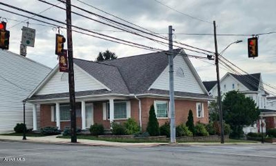 Beautiful 1-story vinyl and brick sided home/building built in 2015 in Town Center at the traffic light in Martinsburg! - you choose usage per borough regs.  Kitchen with island counter bar, dining area, living room open floor plan, plus 2 bedrooms, 2 baths w/laundry on main level, unfinished basement, 4 minisplits for heat + a/c + backup baseboard heat, nice landscaping, blacktop drive w/parking in back.  J-599