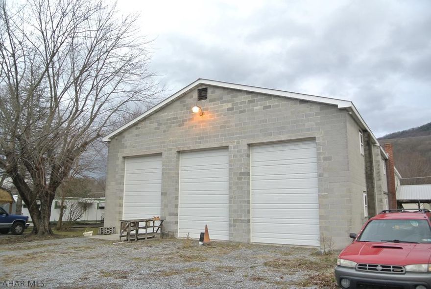 Huge commercial block building with 3 garage bays and office spaces.  Also, has a 3 bedroom home currently being rented for 600 a month plus utilities,